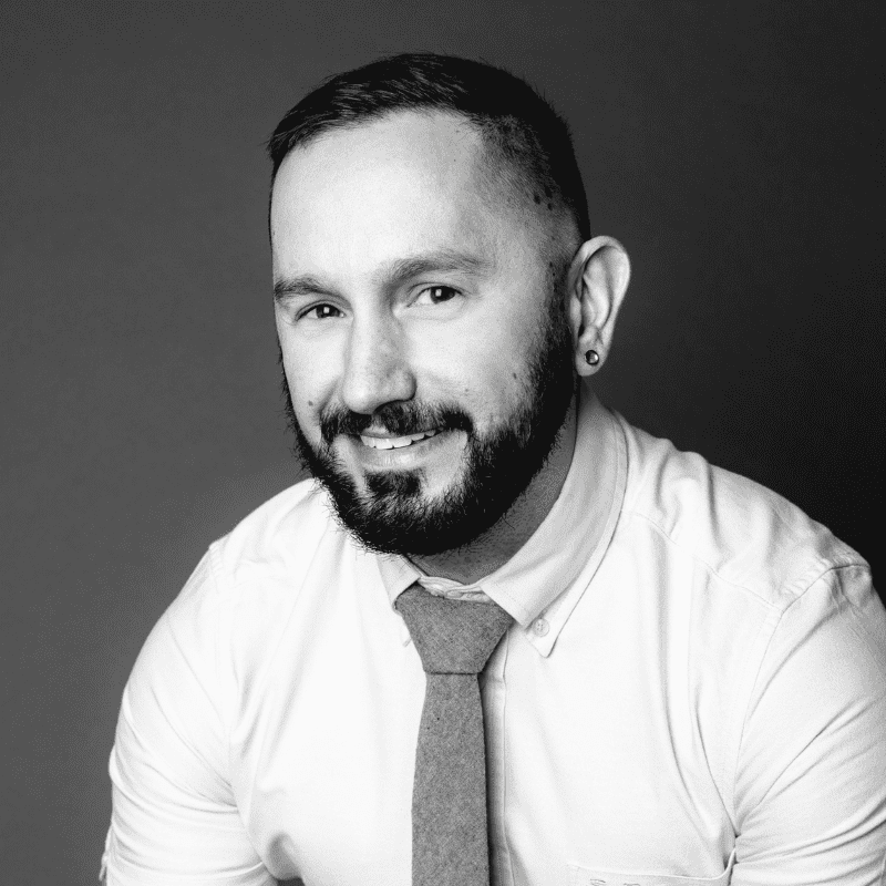 Portrait of Rex, a professional stylist at Maxine Salon, showcasing their expertise and style.
